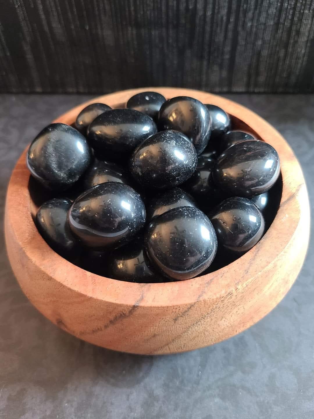 Gumball-sized Apache Tear obsidian tumble stones used for grounding, grief support, and gentle emotional healing. Dark Star Curiosities item
