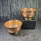 Two copper bowls with a textured surface on a dark background - Dark Star Curiosities