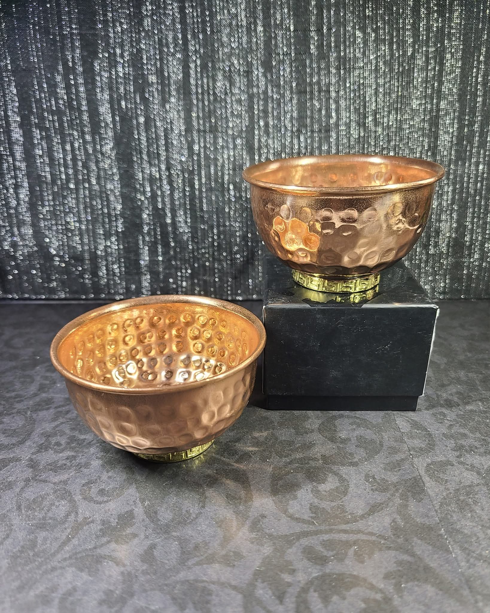 Two copper bowls with a textured surface on a dark background - Dark Star Curiosities