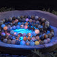 Azurite, hackmanite and chrysocolla crystal/mineral beaded bracelet under UV light to show the orange reactivity