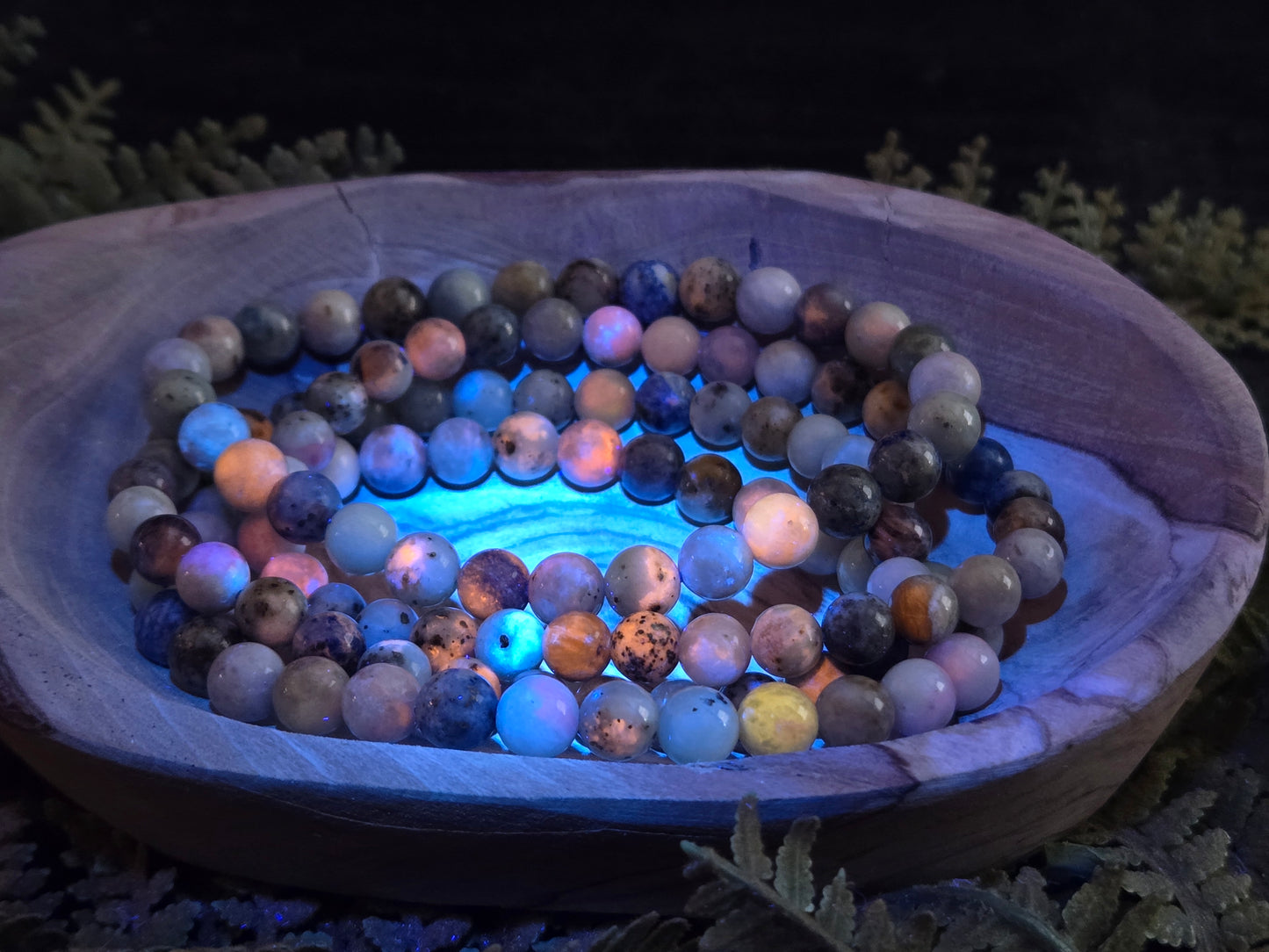 Azurite, hackmanite and chrysocolla crystal/mineral beaded bracelet under UV light to show the orange reactivity